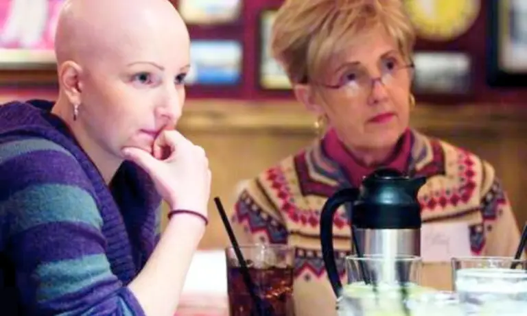 Woman with alopecia listening.