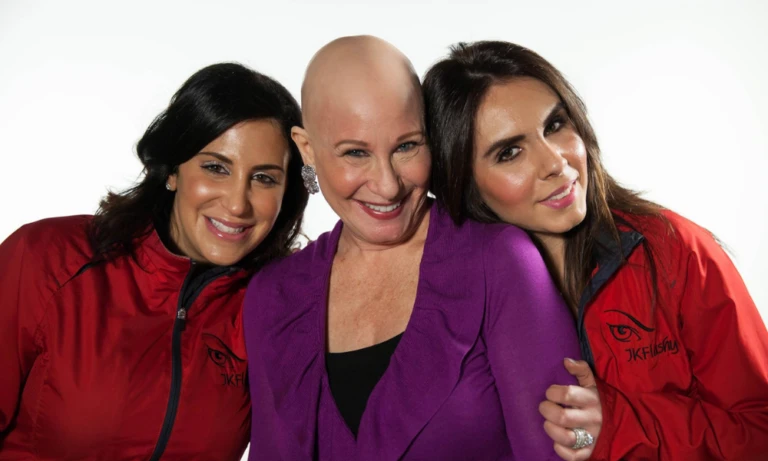 Three woman smiling for photo.